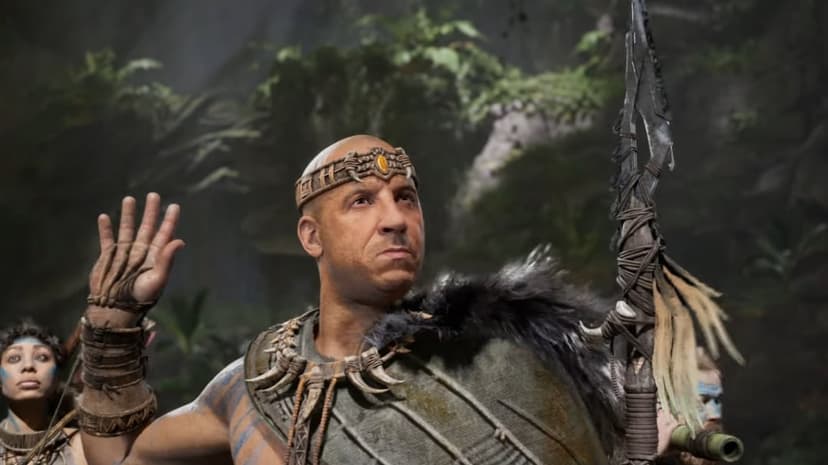 Santiago from ARK II raising his hand in a jungle, wearing a bone crown and holding a feathered primitive spear.