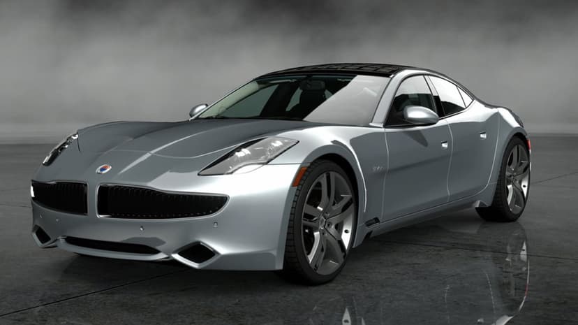 Silver luxury electric sedan with a solar roof parked on a reflective floor in a misty grey studio setting.