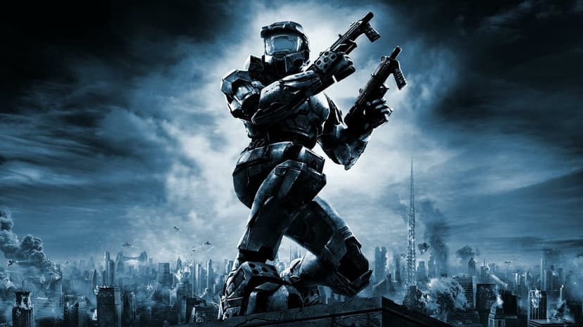 Master Chief kneeling on a rooftop dual-wielding SMGs against a blue-toned futuristic city under attack.