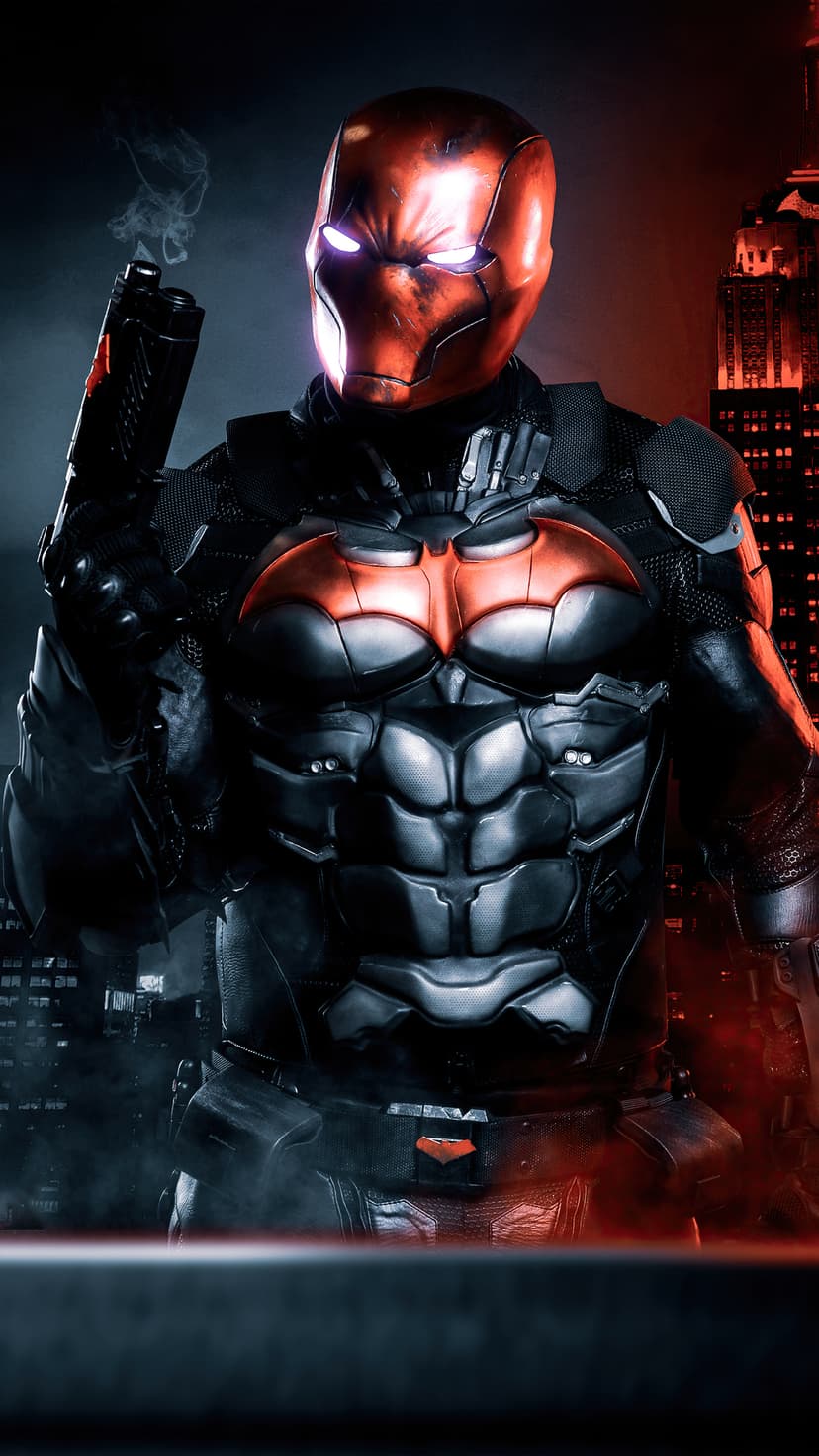 Red Hood stands in dark armor with a red bat logo, glowing white eyes, and a smoking handgun against a city.