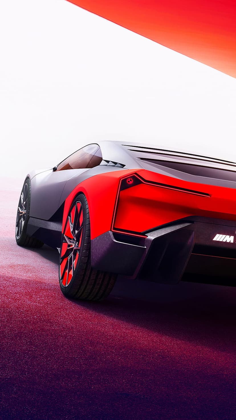 Red and grey BMW concept car with glowing taillights parked on a textured pink and purple gradient surface.