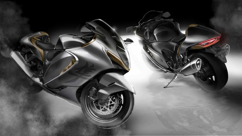 Two silver Suzuki Hayabusa motorcycles with gold accents amidst thick white smoke against a dark background.