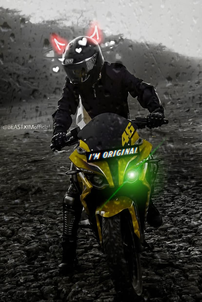 Biker on a yellow and black motorcycle with a green headlight sitting on wet rocks during a rain shower.