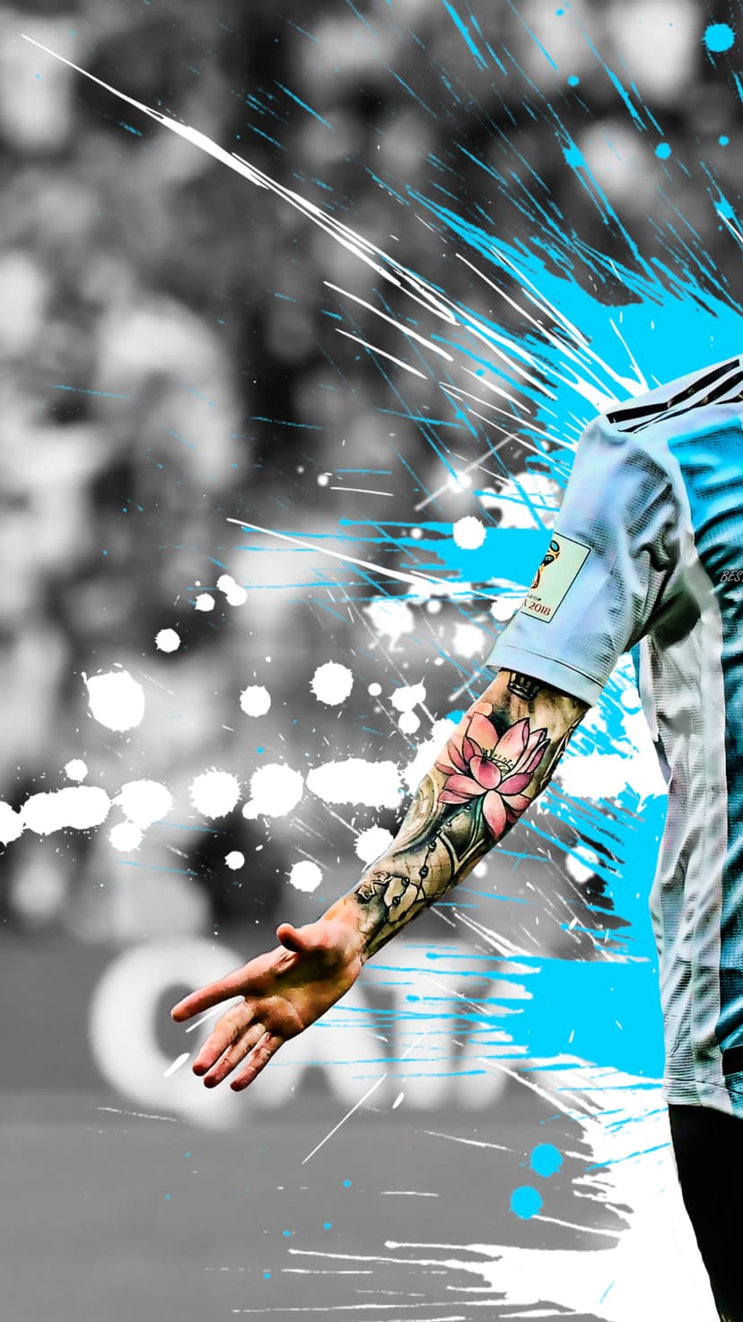 Lionel Messi raises his tattooed arm showing a lotus flower while wearing a blue jersey with a gold FIFA patch.