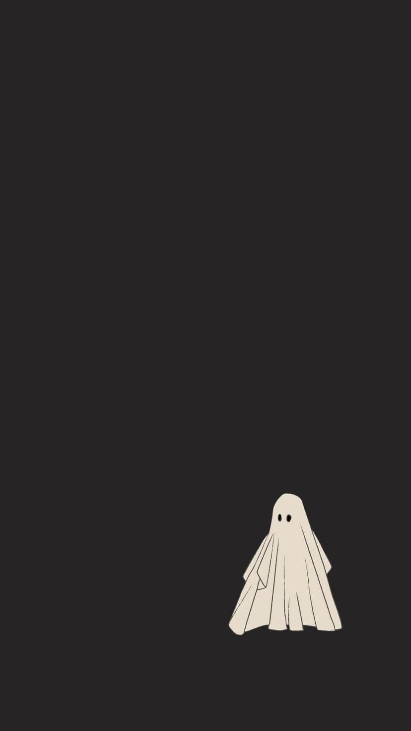 Tiny white cartoon ghost with wide dark eyes standing centered against a solid jet black background.