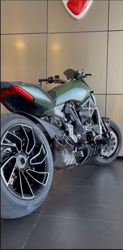 Green Ducati Diavel motorbike with custom wheels and exhausts