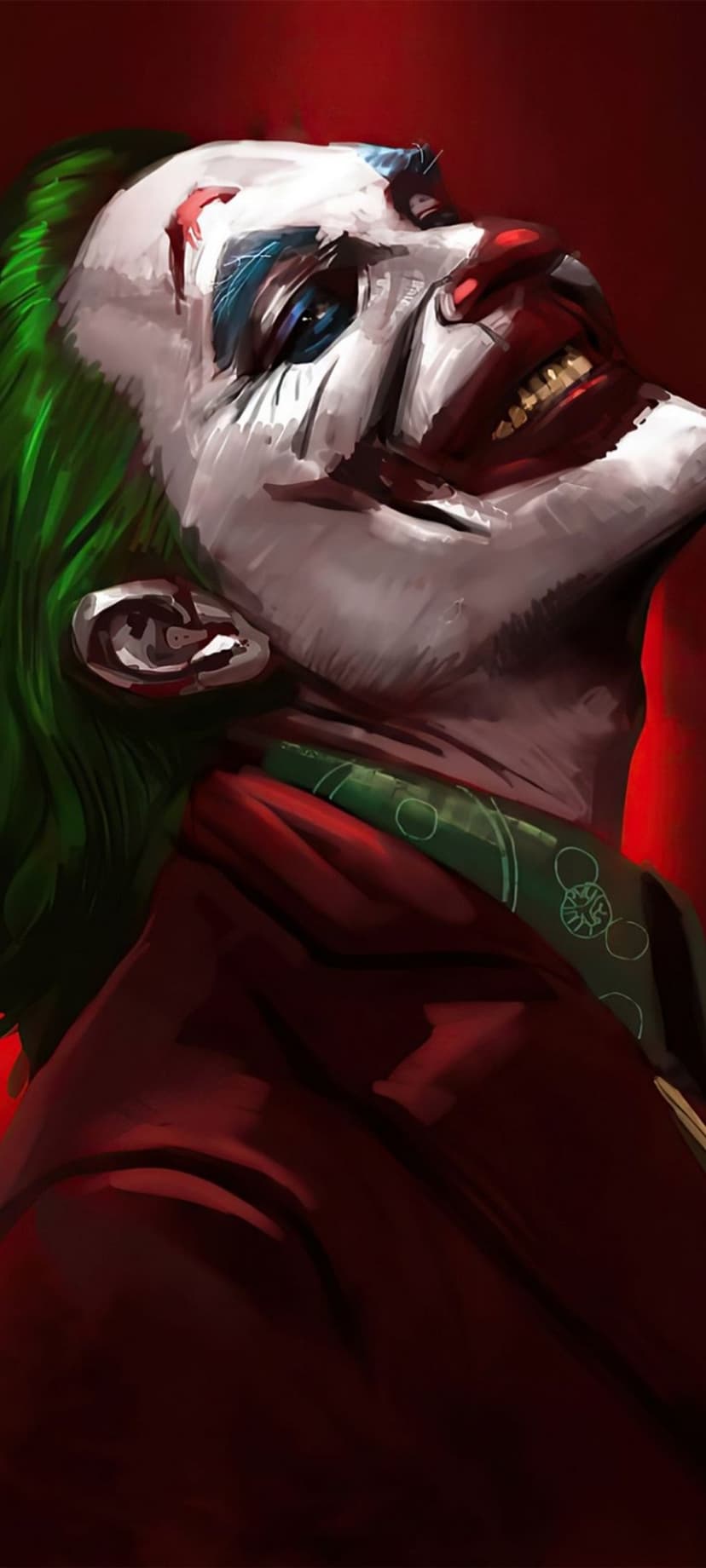 Arthur Fleck laughs with smeared white face paint and green hair while wearing a red suit against a dark background.