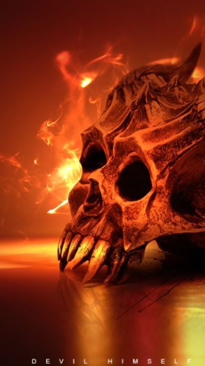 Demonic skull with glowing eyes sits on a reflective surface surrounded by orange flames and wisps of fire smoke.