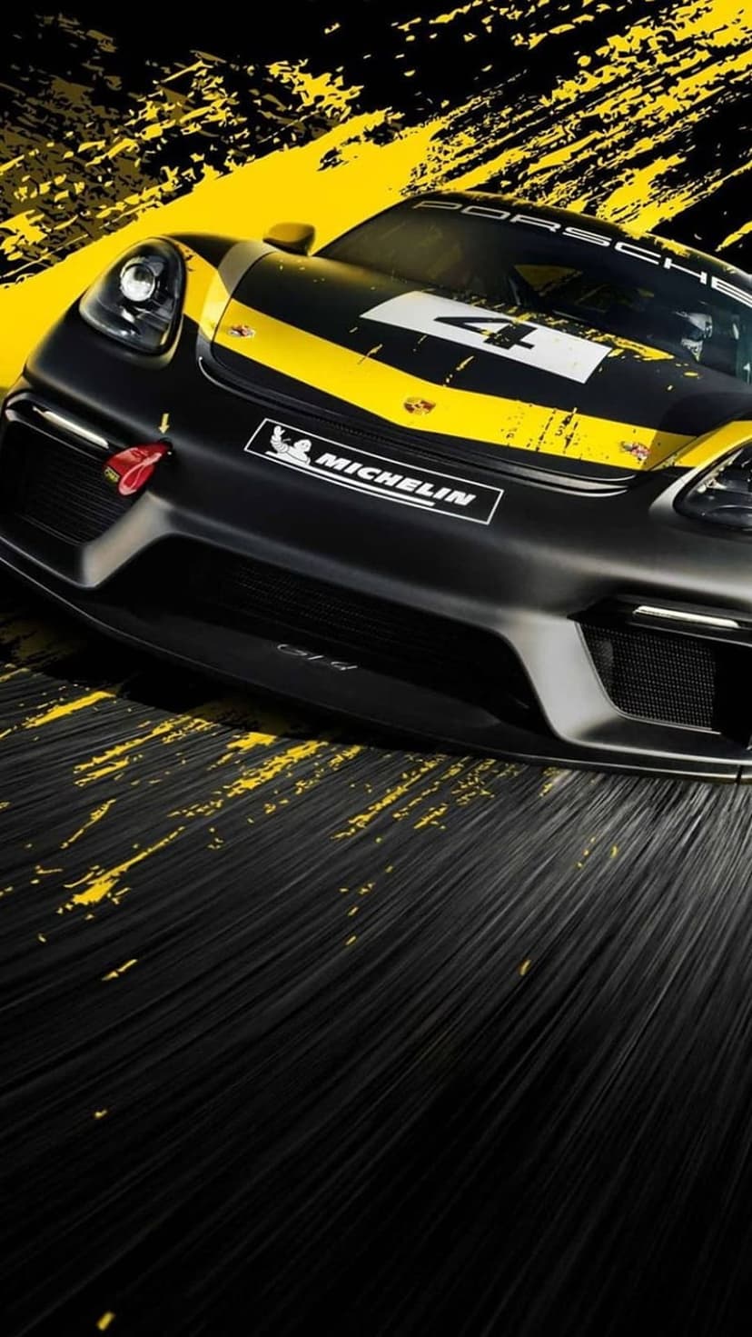 Porsche GT4 race car with a yellow stripe and number 4 parked on a black surface with yellow paint splatters.