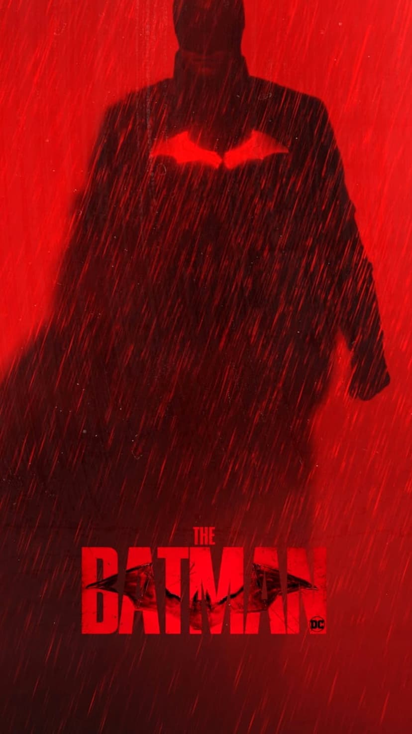 Batman stands in silhouette under heavy rain with a glowing red bat symbol on his chest against a dark red backdrop.