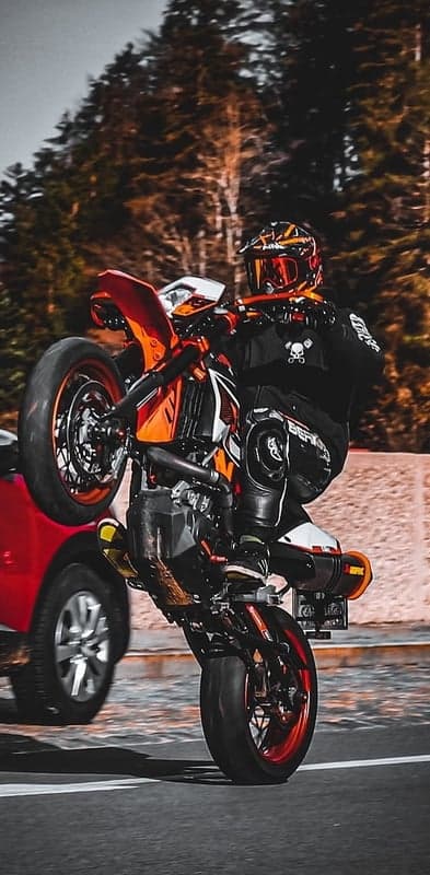 Dynamic Stunt Rider Wheelie Action Mobile Wallpaper