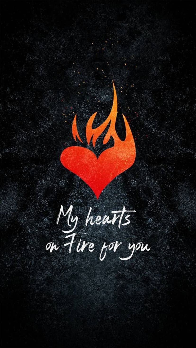 Glowing red heart engulfed in orange fire with white script text below on a textured black background.