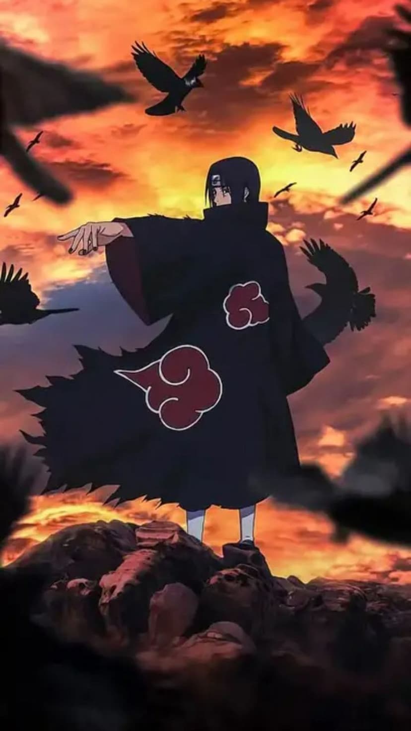 Itachi Uchiha wearing an Akatsuki cloak stands on rocks as black crows fly against a vibrant orange sunset sky.