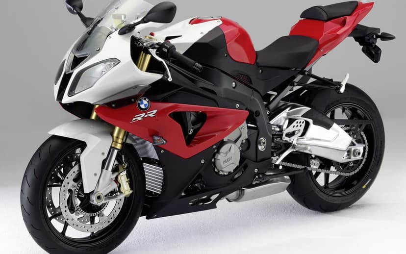 BMW S1000RR sportbike in red, white, and black with gold forks on a clean white studio background.