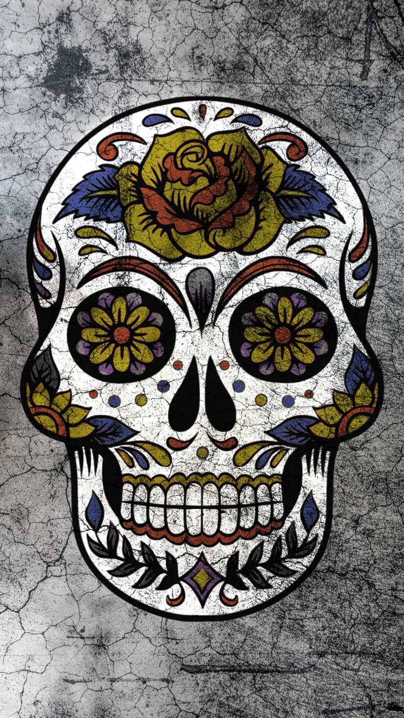 Sugar skull decorated with a yellow and red rose on a cracked concrete wall with colorful floral patterns.