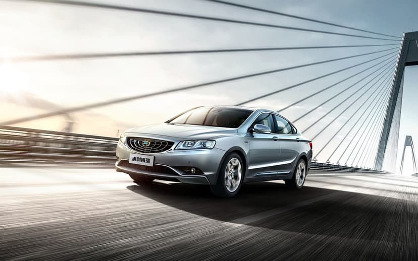 Silver sedan driving at high speed across a modern cable-stayed bridge with motion blur and sun flare.