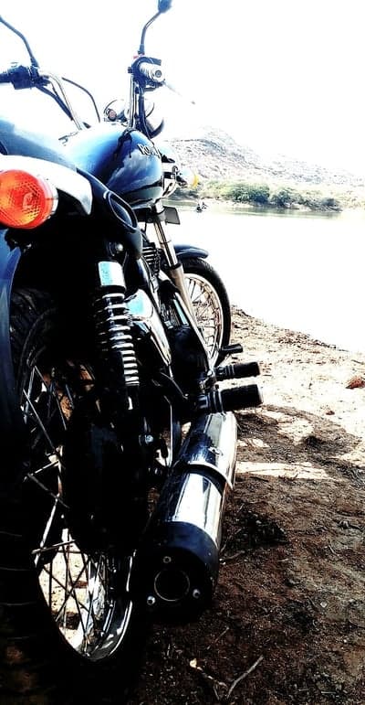 Rugged Motorcycle Detail by Serene Lake Phone Background