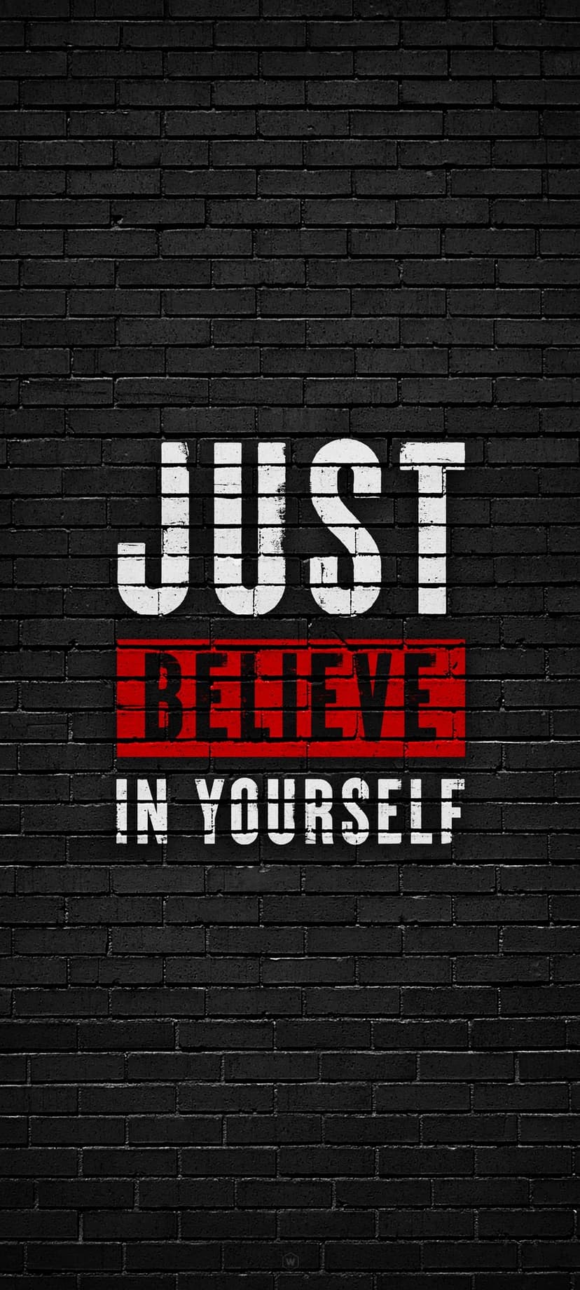 Motivational text reading Just Believe in Yourself painted in white and red on a dark textured brick wall.