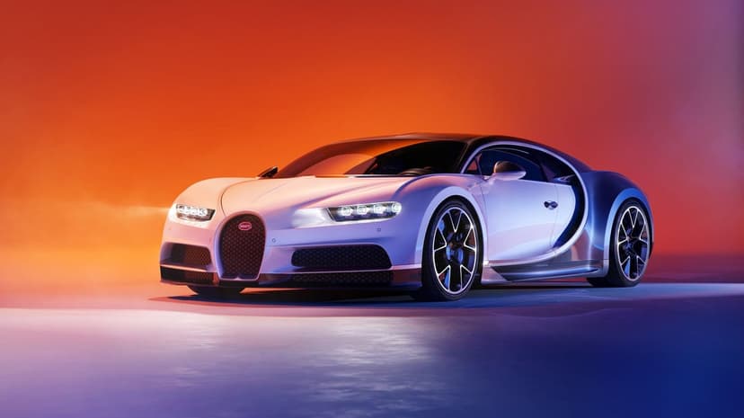 White Bugatti Chiron hypercar in a studio with orange and purple gradient lighting and glowing LED headlights.