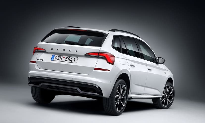 Rear view of a white Skoda Kamiq SUV with LED taillights in a minimalist grey studio environment.