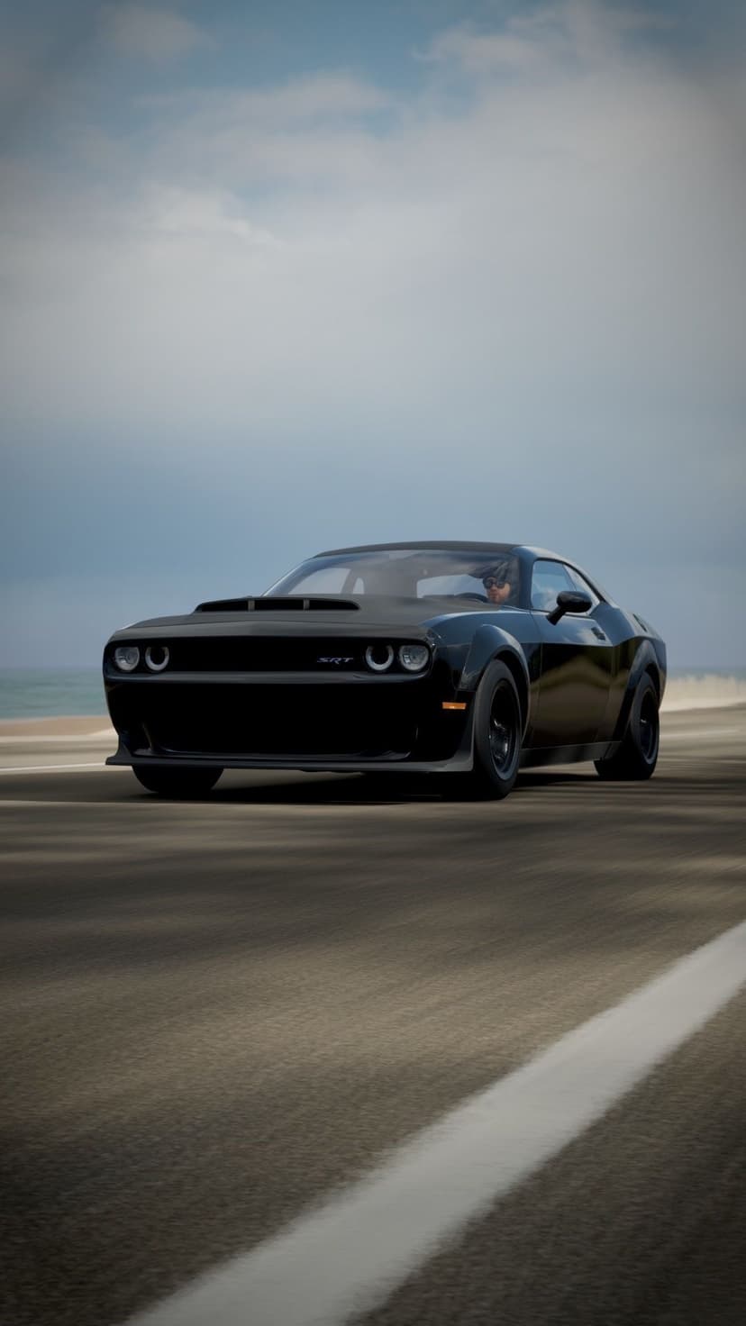 Black Dodge Challenger SRT Demon with glowing headlights driving on a blurred road under a moody overcast sky.