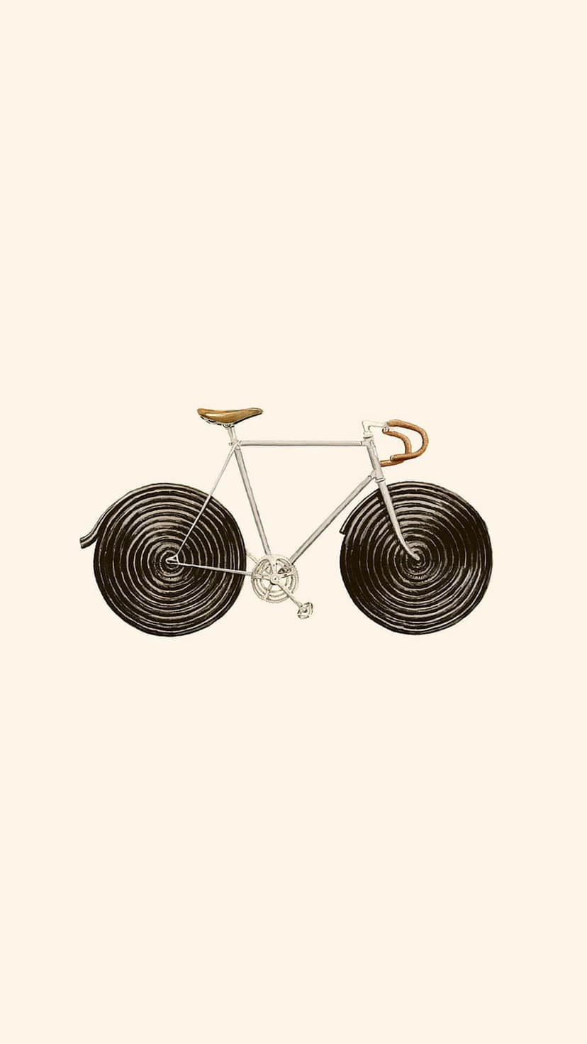 Silver vintage bicycle with a brown leather saddle and dark spiral wheels stands against a plain light backdrop.