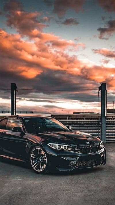 Sleek Black BMW M2 Sports Car Sunset Phone Wallpaper