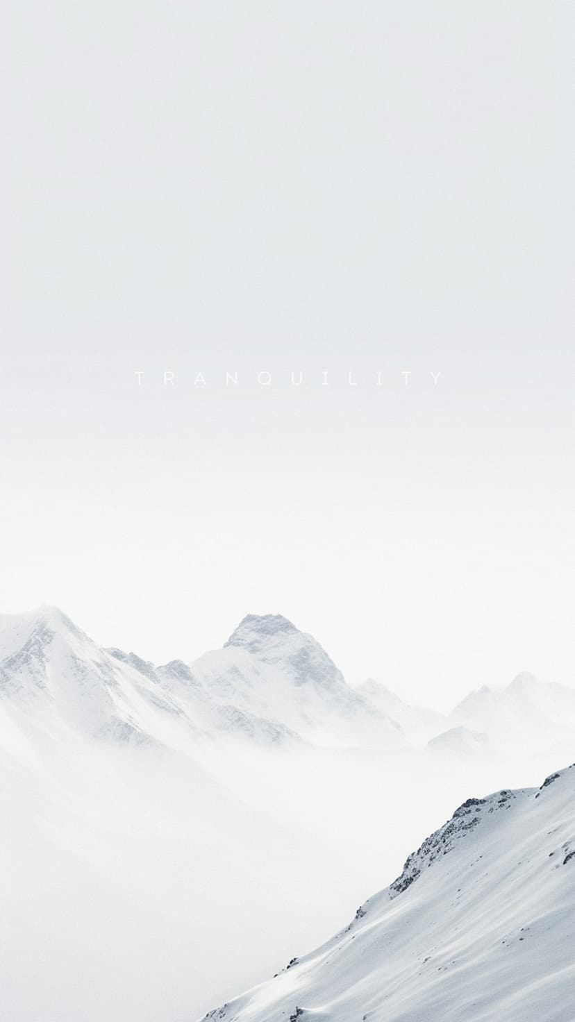Snow-capped mountain peaks emerge through thick white mist with the word Tranquility centered in the upper frame.