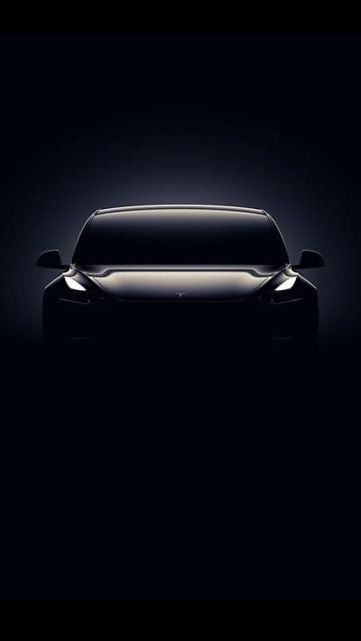 Sleek Tesla Electric Car Silhouette with Glowing LED Headlights