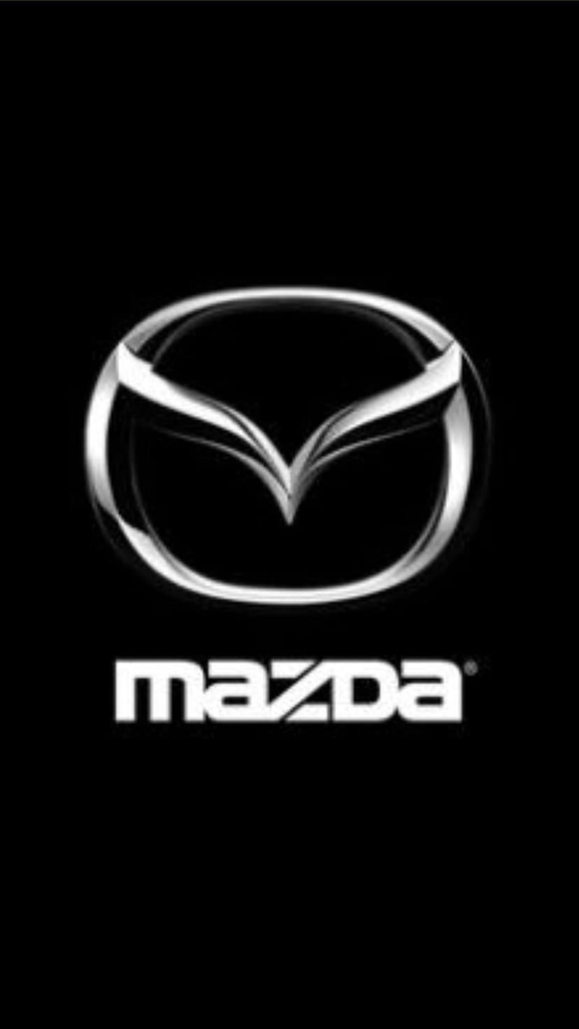 Silver Mazda wing logo above white sans-serif text centered on a solid matte black vertical background.