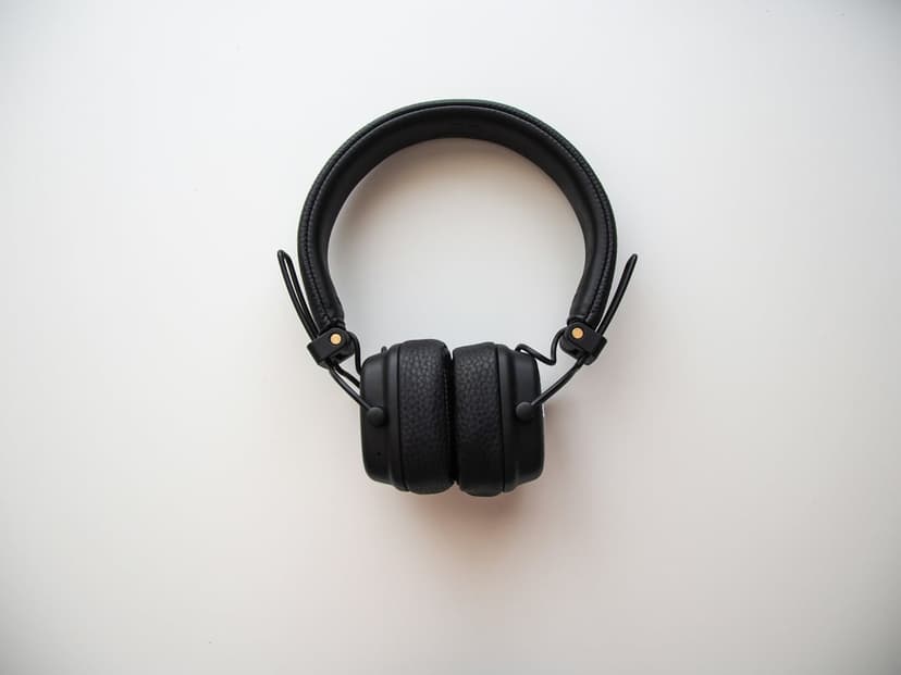 Black Marshall on-ear headphones with padded earcups and a textured headband centered on a plain white background.