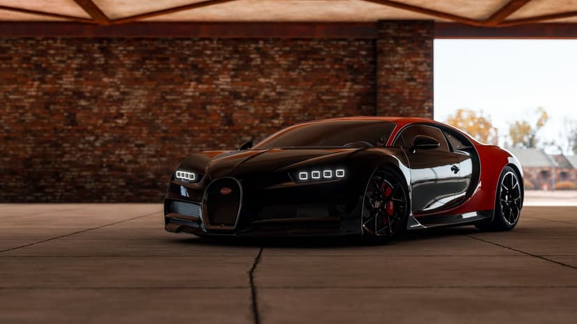Front view of a black and red Bugatti Chiron with glowing LED headlights in an industrial brick garage.