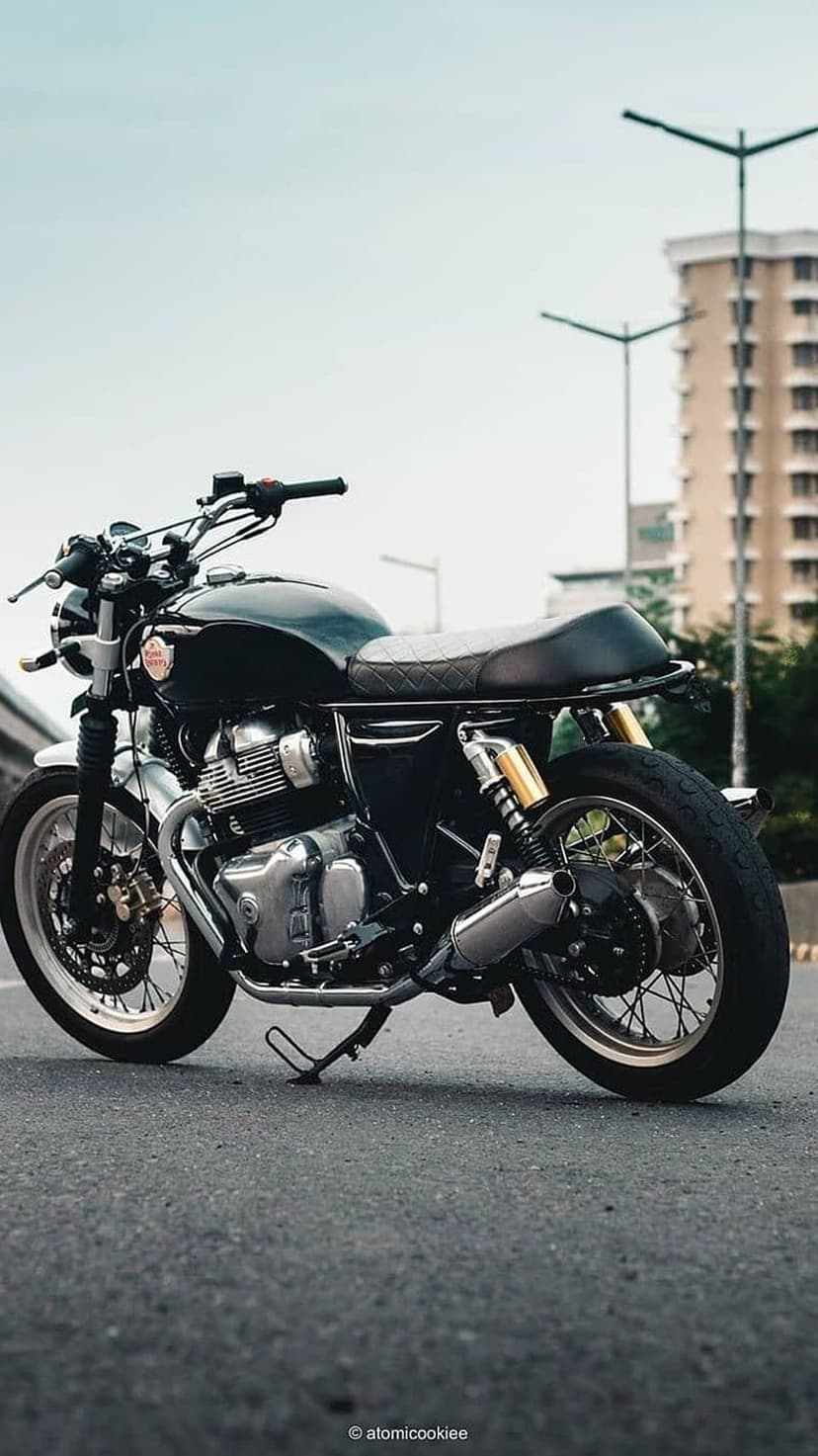 Royal Enfield Interceptor 650 motorcycle with chrome details and a black seat parked on an urban asphalt road.