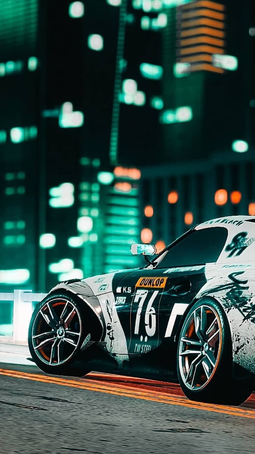 Black and white racing car with number 76 speeds past blurred neon city lights in a low-angle vertical shot.