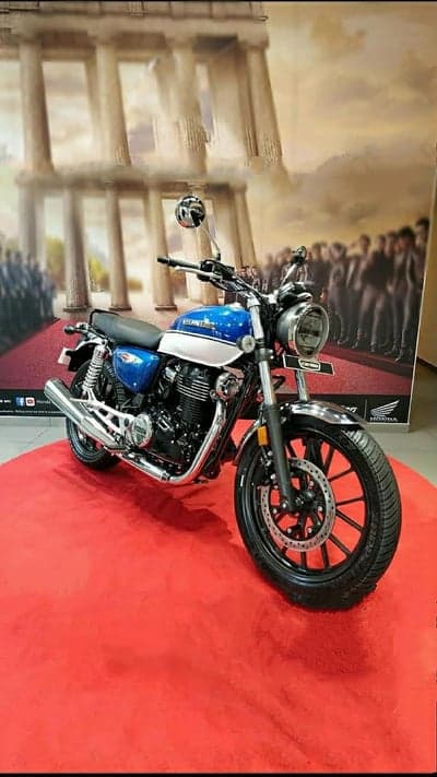 Blue and white Honda motorcycle on red carpet