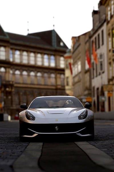 Ferrari F12berlinetta parked on European cobblestone street