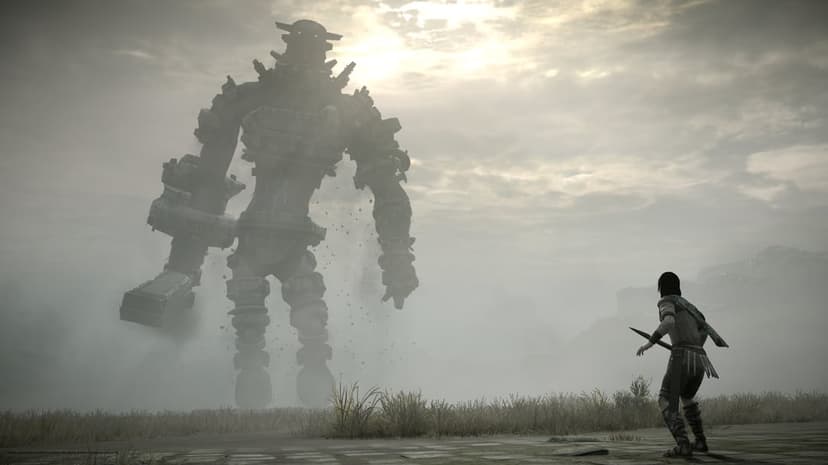 Giant stone titan looms over a small warrior with a sword in a misty, gray landscape under a bright sun.