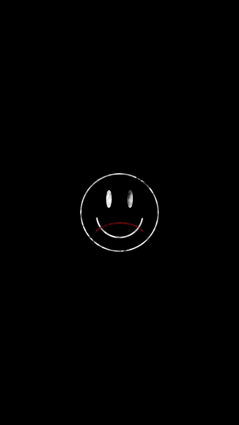 Frowning white outline face with two dots for eyes and a red downturned mouth centered on a solid black background.