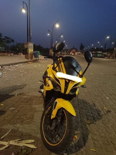 Yellow sport bike parked at night with streetlights