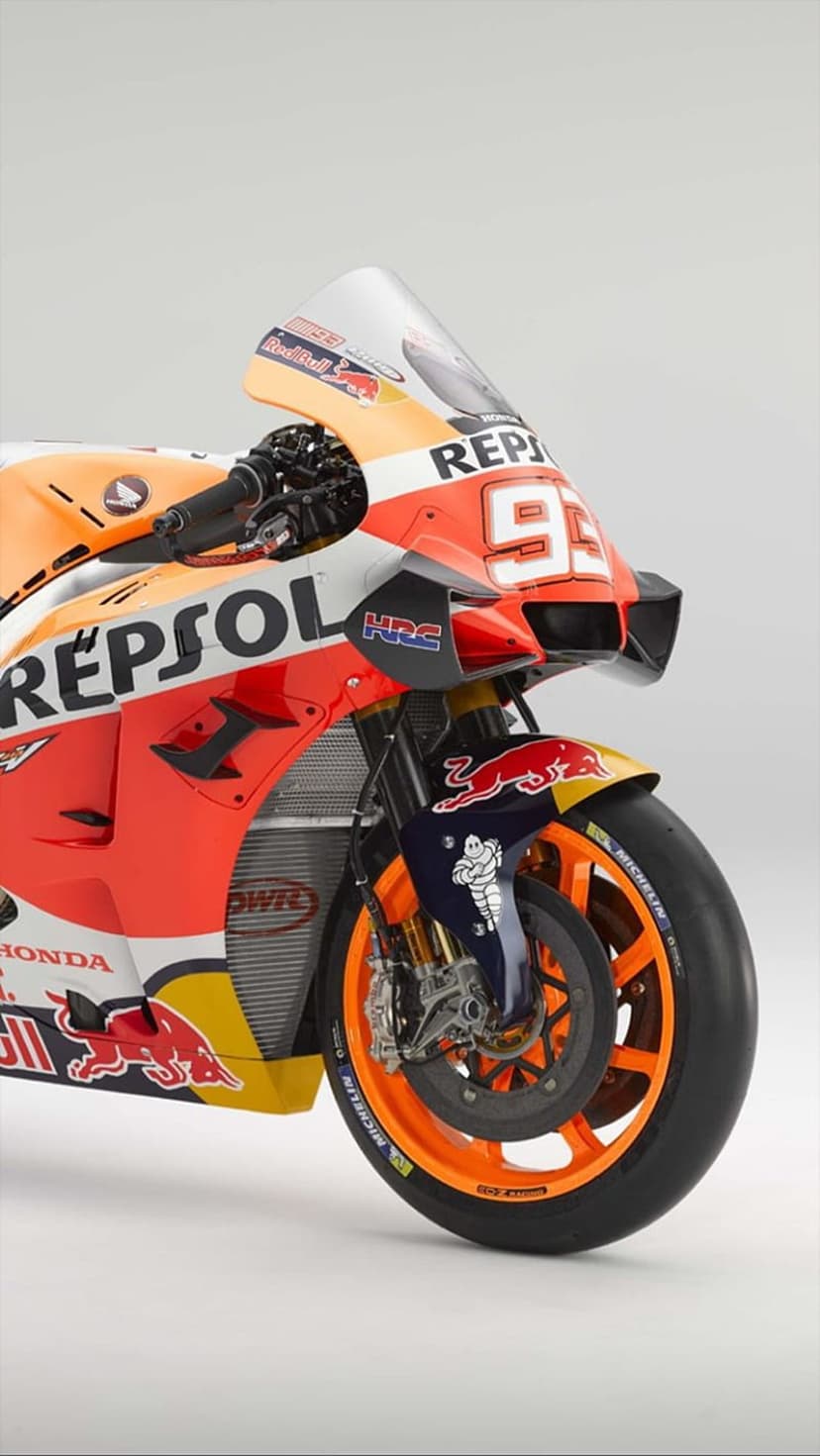 Repsol Honda RC213V racing bike featuring orange wheels and number 93 graphics in a sharp vertical close-up.