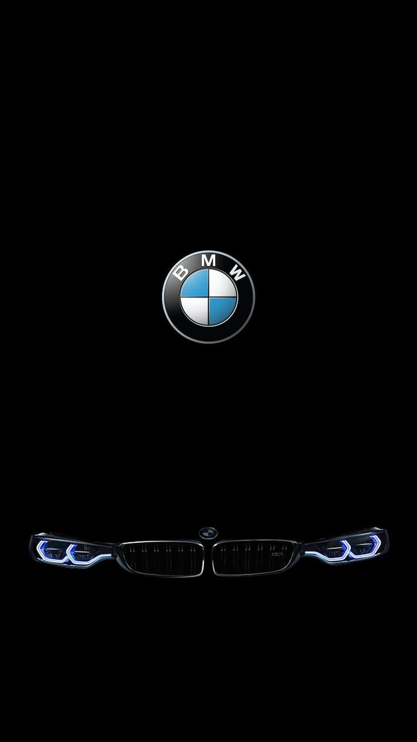 BMW emblem centered above illuminated blue daytime running lights and a car grille on a pitch-black backdrop.