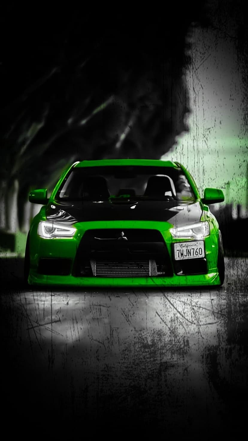 Mitsubishi Lancer Evolution X with a black hood and intercooler parked on a scratched, dark textured surface.