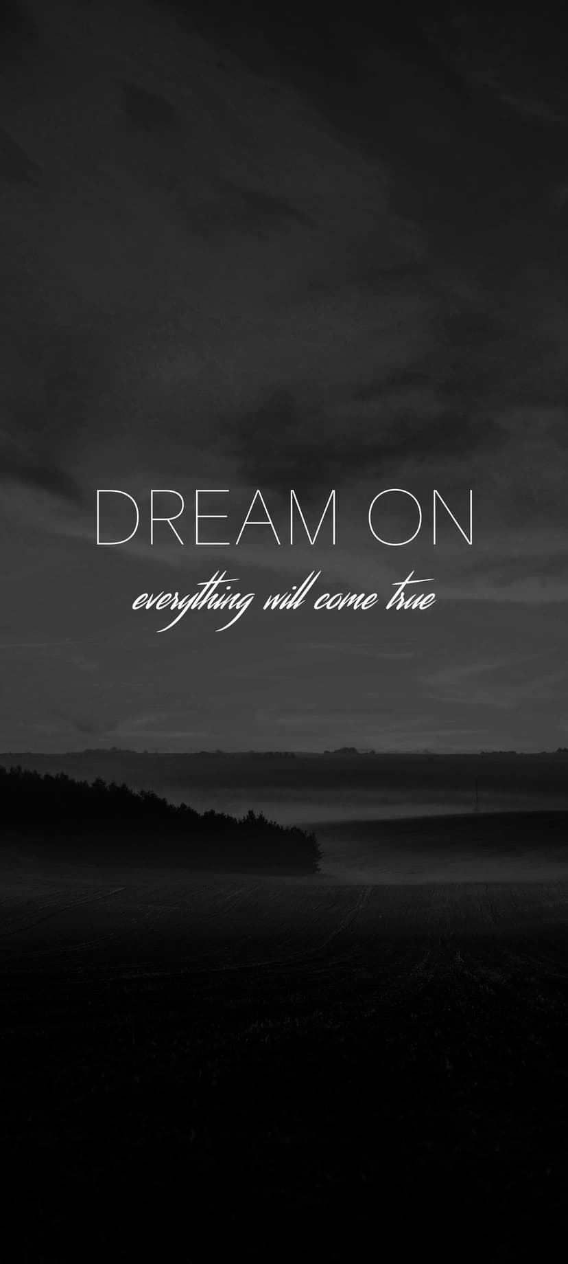 Rolling hills shrouded in thick mist beneath a cloudy sky featuring the text Dream On in a minimalist layout.
