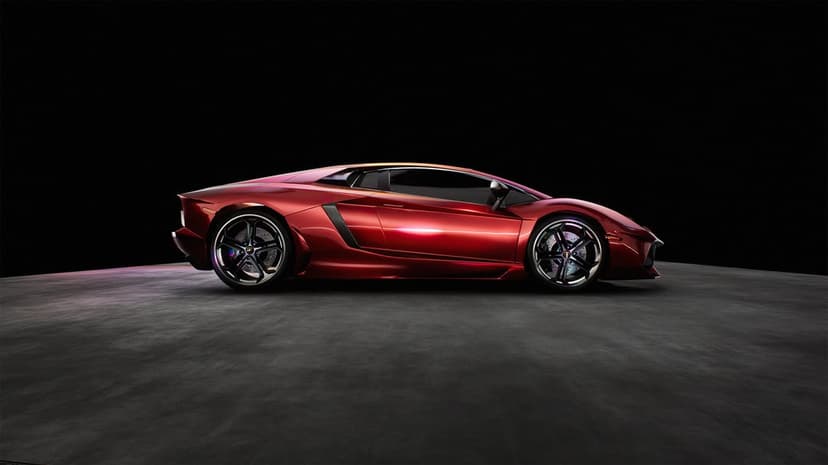 Profile of a metallic red sports car on a dark concrete floor against a solid black studio background.