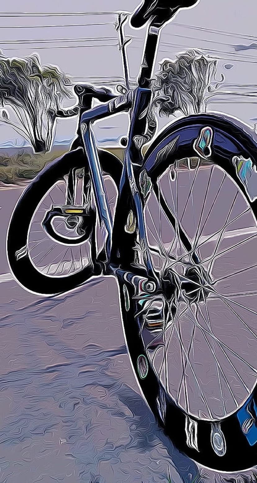 Road bicycle frame and spinning wheels move past a blurred landscape for a vertical smartphone display.