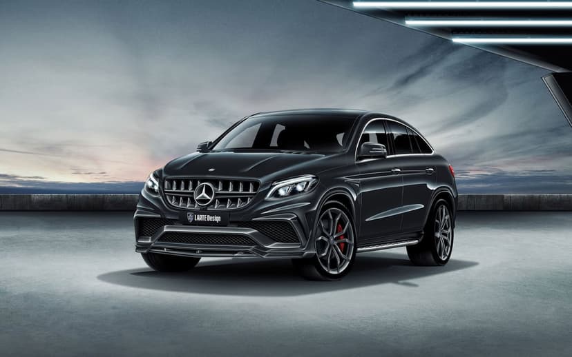 Black Mercedes-Benz GLE Coupe with LARTE Design body kit in a modern garage against a twilight sky.