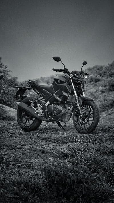 Black Yamaha Motorcycle Parked on Grassy Hillside