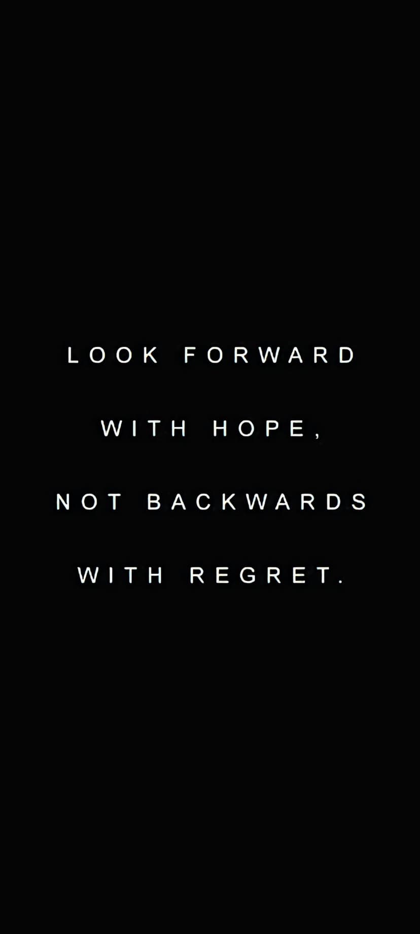 White sans-serif text reading Look forward with hope, not backwards with regret on a solid black background.