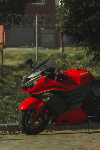 Red Kawasaki Ninja Motorcycle Parked Outdoors