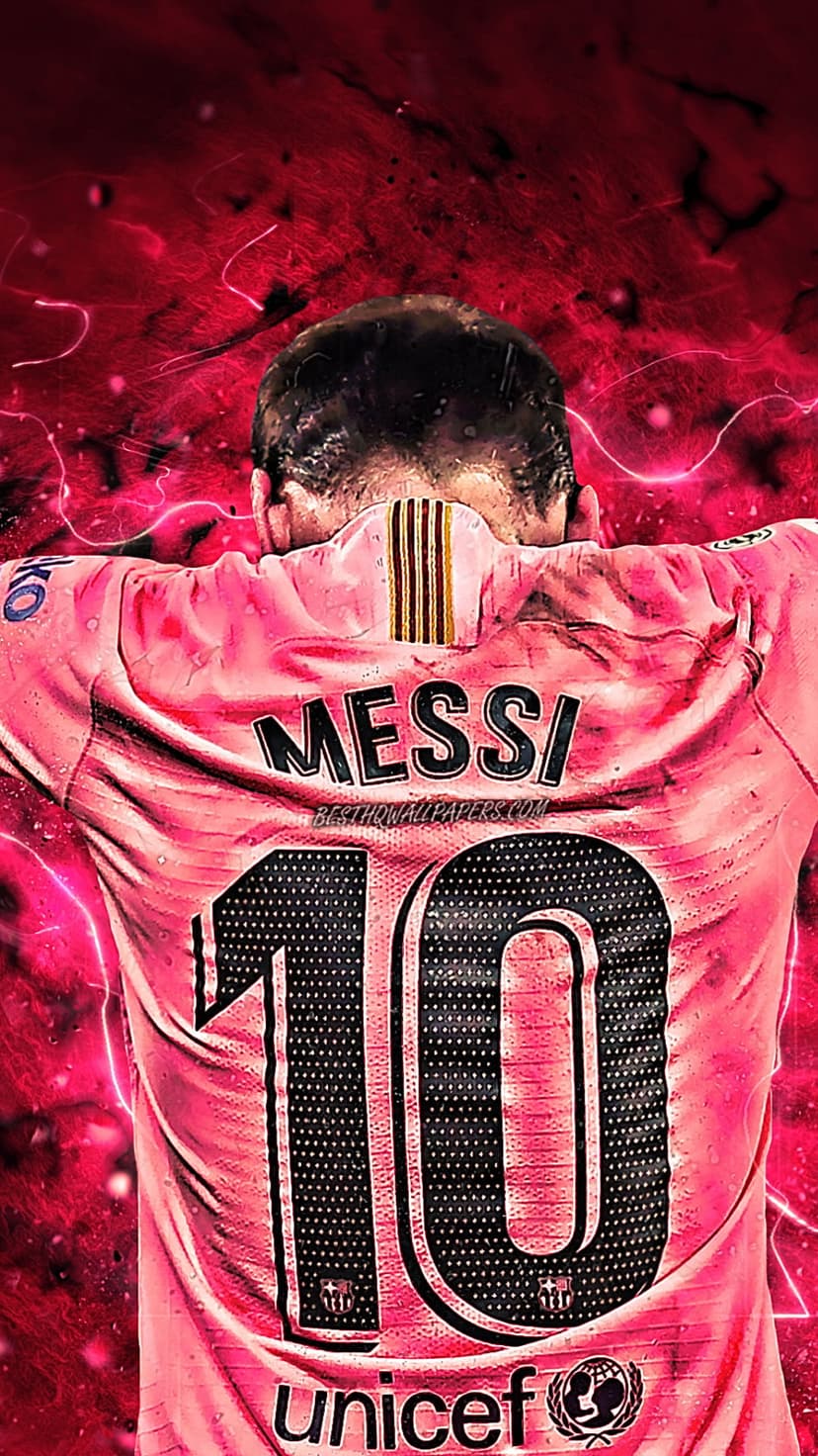 Lionel Messi in a pink Barcelona number 10 jersey stands before a red background with white lightning bolts.